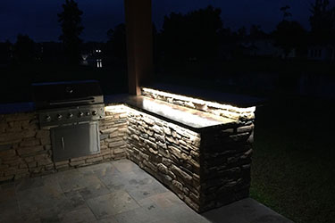 Large grill and counters with backlight at night in Wisconsin